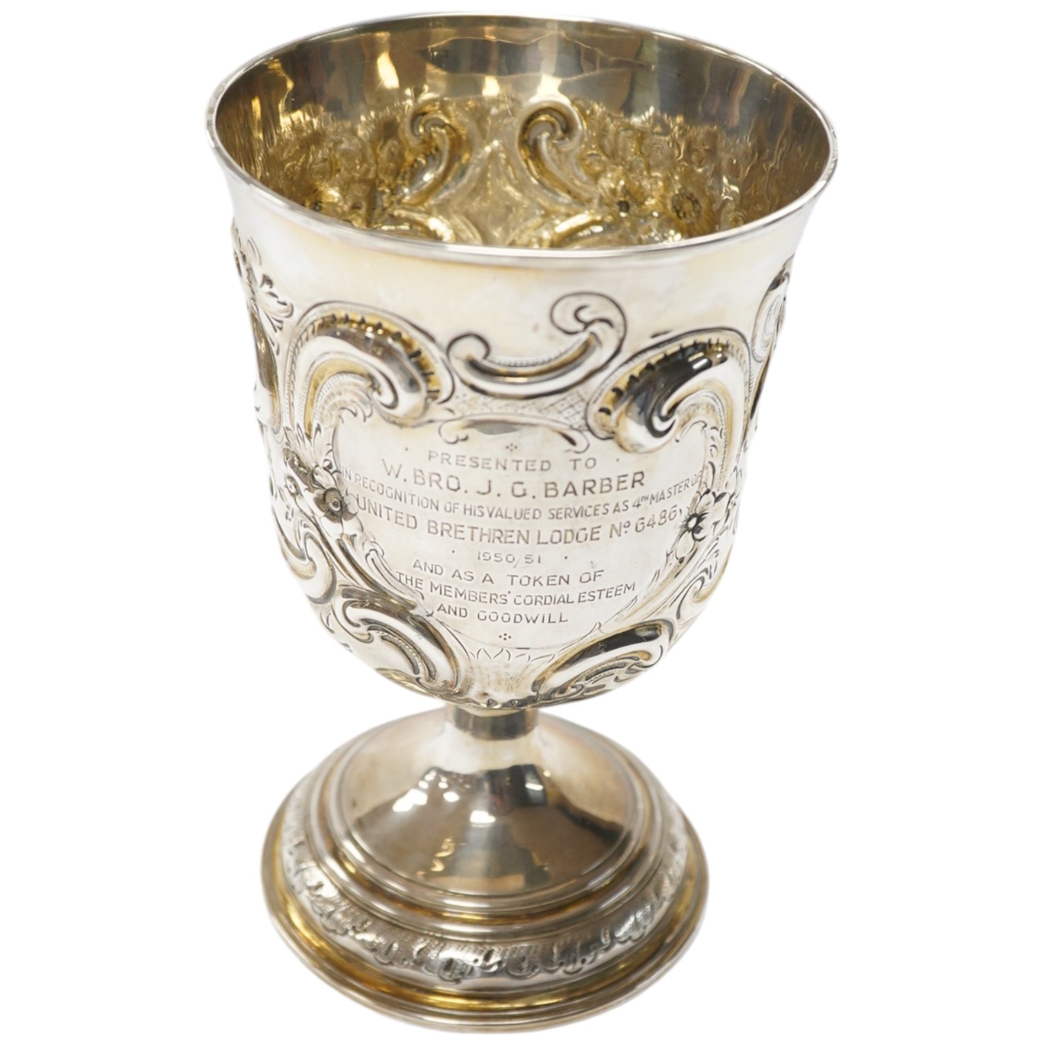 A George II silver goblet, with later embossed decoration and inscription, maker RB London, 1728, 16.6cm, 8.9oz. Condition - fair